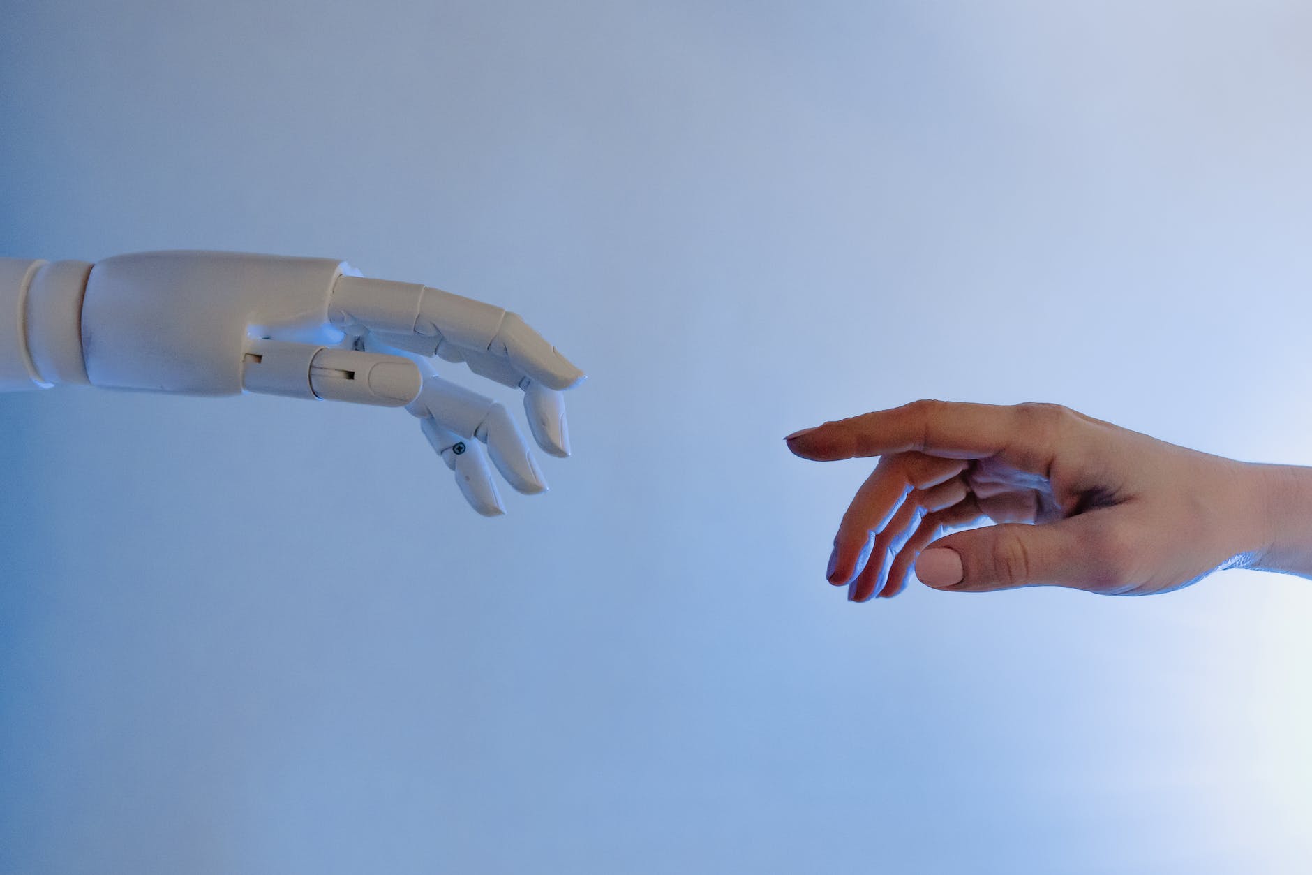 person reaching out to a robot | Top Mind-Blowing Artificial intelligence